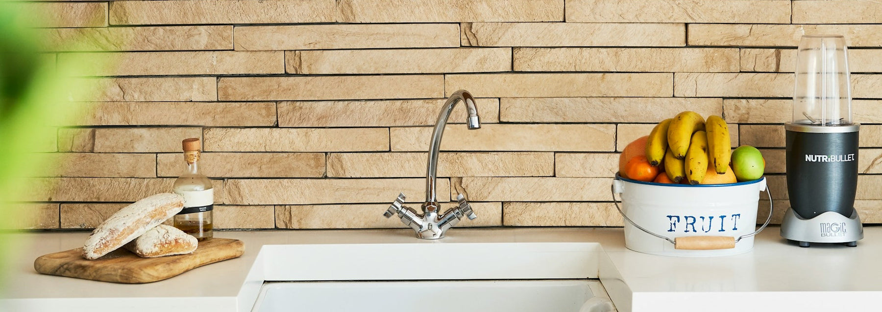 kitchen sink with stone backsplash