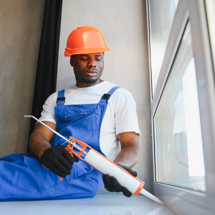 man applying caulking